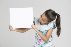 cute girl showing blank placard