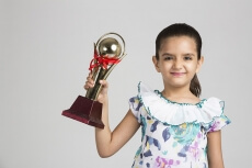 cute kid holding trophy