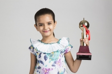 cute kid holding trophy