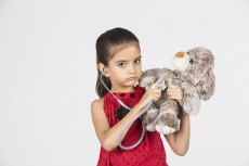 cute little girl imitating as doctor