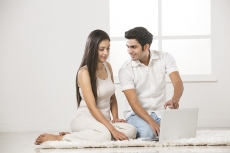 couple at home working on laptop