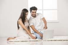 couple at home working on laptop