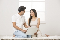 couple at home working on laptop