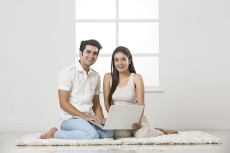 couple at home working on laptop