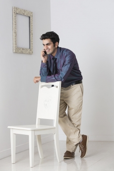 man in formals talking on phone at home