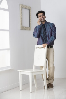 man in formals talking on phone at home