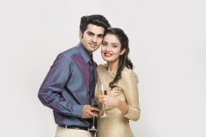 couple posing with champagne glasses 
