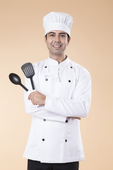 chef posing with spatula and ladle
