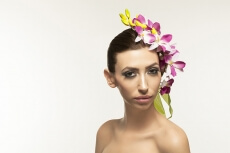 beautiful young woman posing with flowers in hair