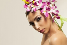 beautiful young woman posing with flowers in hair