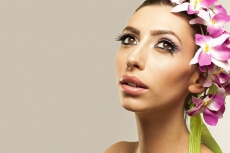 beautiful young woman posing with flowers in hair