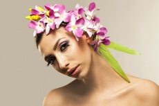 beautiful young woman posing with flowers in hair
