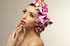 beautiful young woman posing with flowers in hair