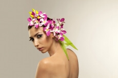 beautiful young woman posing with flowers in hair