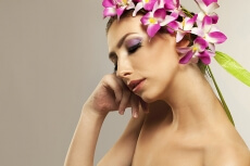 beautiful young woman posing with flowers in hair