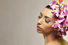 beautiful young woman posing with flowers in hair