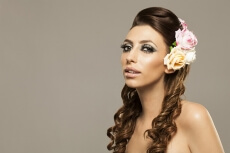 beautiful woman posing with roses in hair