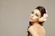 beautiful woman posing with roses in hair