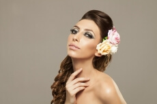 beautiful woman posing with roses in hair