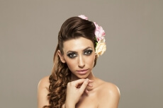 beautiful woman posing with roses in hair