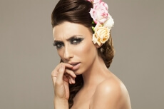 beautiful woman posing with roses in hair
