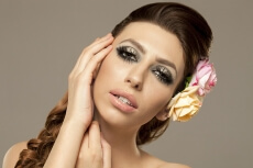 beautiful woman posing with roses in hair