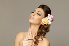 beautiful woman posing with roses in hair