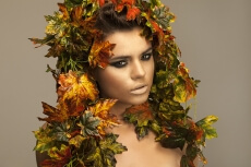 woman covered in leaves 