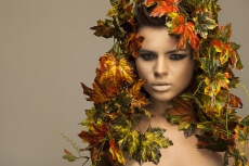 woman covered in leaves 