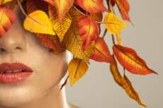 model covered with leaves portraying autumn