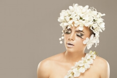 woman covered with white flowers
