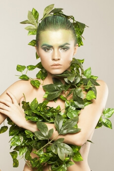 woman covered with green leaves