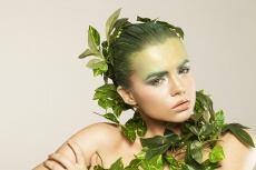 woman covered with green leaves