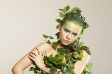 woman covered with green leaves