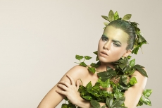 woman covered with green leaves