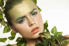 woman covered with green leaves