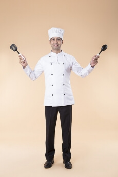 chef posing with spatula and ladle