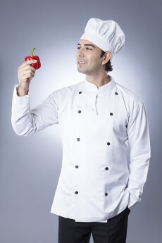 chef posing with red capsicum