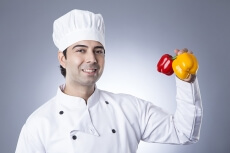 chef posing with red capsicums