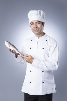 chef posing with fish 