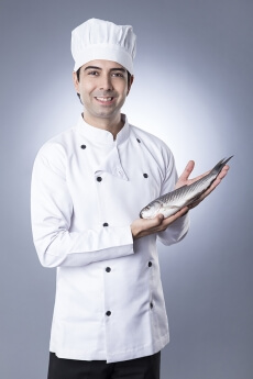 chef posing with fish 