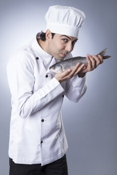 chef posing with fish 