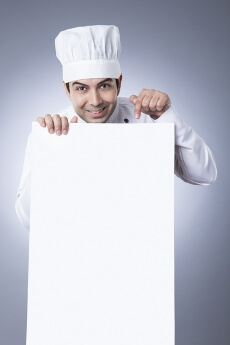 chef pointiing at placard