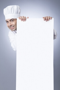 chef posing with placard