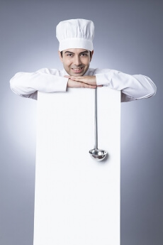 chef posing with placard