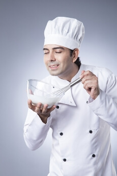 chef churning with egg beater