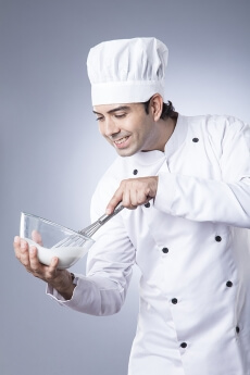 chef churning with egg beater