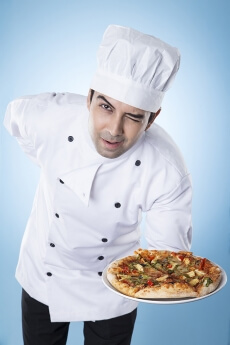 chef posing with pizza