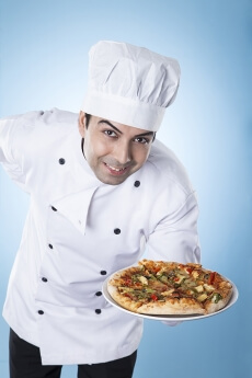 chef posing with pizza