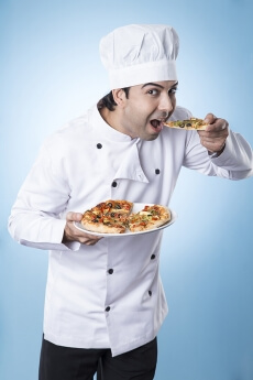 chef posing with pizza